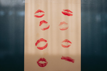 red lipstick kisses on yellow paper