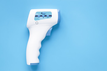 Thermal radiation thermometers. Infrared thermometer. Temperature gun, to measure temperature from a distance without contact with the object to be measured. Copy, text space.