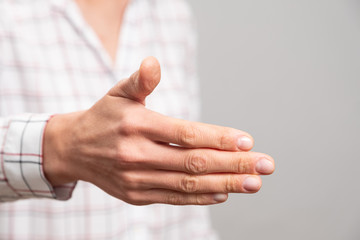 Female hand showing a greeting sign for a handshake