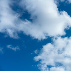 a group of white cumulus clouds in the blue sky as a natural background