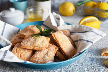 Lemon cookies with sugar and zest on the kitchen table.