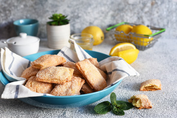 Lemon cookies with sugar and zest on the kitchen table.