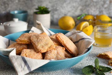 Lemon cookies with sugar and zest on the kitchen table.