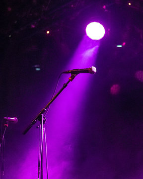 Microphone On Stage With Purple Stage Lights