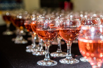 lots of wine glasses with a drink