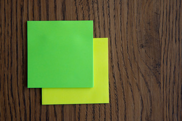 Colorful sticky notes on wooden background image.
