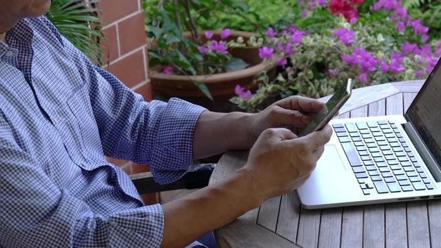Businessman typing on his cellphone at home. Home office or work from home concept.