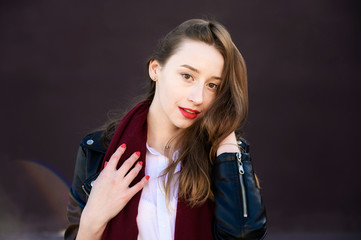 Fototapeta premium Spring portrait of a smiling beautiful girl with emotions in the sun outdoors