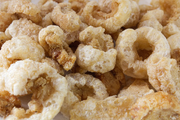 Crispy pork rinds, pork cracklings, fried pork rinds, traditional Thai food and appetizer