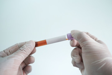 Hand of doctor holding test tube in hospital with copy space,covid-19 concept