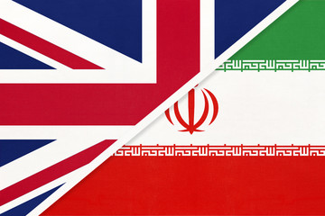United Kingdom vs Iran national flag from textile. Relationship between two european and asian countries.