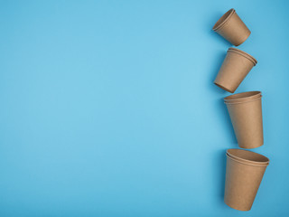 Paper cups on a blue background.