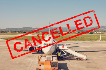 Plane parking at the airport with the word cancelled.