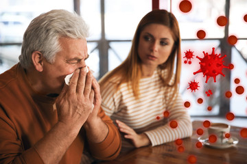 Sick senior man in cafe. Dangerous virus