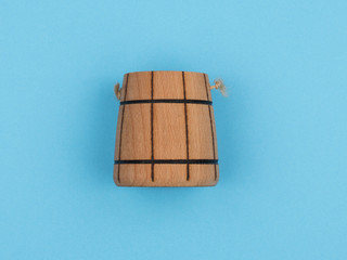 Wooden capacity of environmentally friendly materials on a blue background.