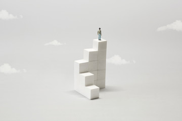 man on the top of white minimal abstract stairs