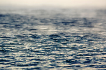 Texture of sea cold blue water of the winter sea over which white steam stretches