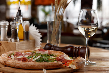 pizza with jamon and herbs