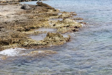 The sea crashes into the rocky coast. Shore of Mediterranean sea in Turkey. Alanya.