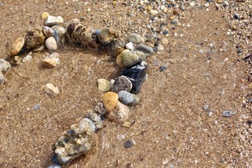 Sand and pebbles. Mediterranean seashore in Turkey. Alanya. Concept.