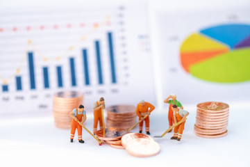 Miniature People: Worker stack of coin analyst graph with copy space using as background money,...