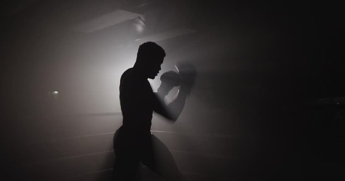 Silhouette of boxer preparing to fight