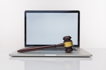 Workspace of lawyer with laptop blank white screen and law wooden gavel,legal book and brass scale...