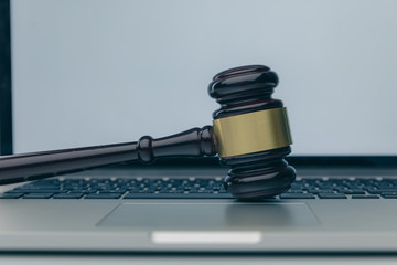 Workspace of lawyer with laptop blank white screen and law wooden gavel,legal book and brass scale...