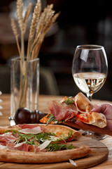 pizza with jamon and herbs