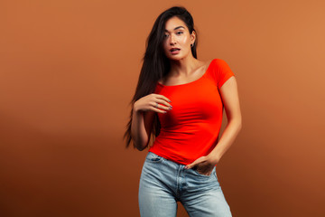 Obraz premium young pretty asian woman cheerful smiling posing on warm brown background, lifestyle people concept