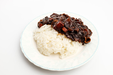 Jjajang rice in a dish on a white background