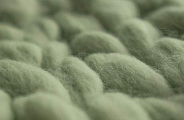Sofia, Bulgaria - March 24, 2020. Green knitted wool pattern. Cozy wool.