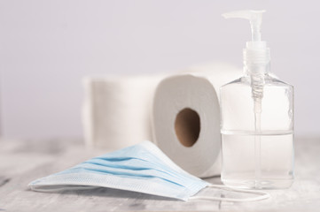 Sanitizer, hand sanitizer, against coronavirus. Medical and toilet paper mask. Coronavirus, and cleanliness.