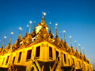 Wat Ratchanadda in the night with half moon and a clear blue sky  close up - Architecture Photography