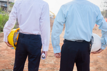 Two business people holding hardhat safety Standing outdoor Teamwork management project