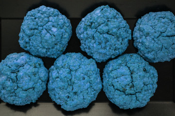 homemade baked blue cookies on black plate