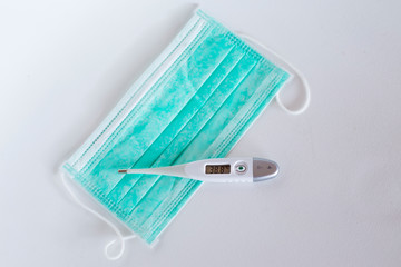 Surgical ear-loop mask and thermometer