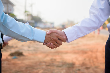 Business partner shake hand agreement  project building estate construction