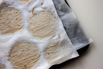 empty oven-tray with traces on paper from cookies