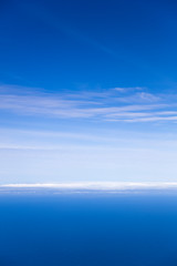 Naklejka na ściany i meble Blue sea and sky horizon with clouds