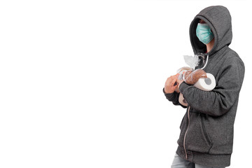 The concept of coronavirus panic, a girl in a sweatshirt with a hood and a mask carries rolls of toilet paper and packages with cereals, buckwheat and rice. Isolated on a white background.