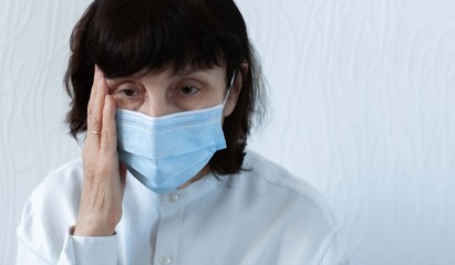 Coronavirus quarantine and Air pollution pm2.5 concept. Old sick woman wearing blue respirator mask for protect. Wuhan, China epidemic virus symptoms background.