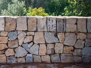 Stone wall of fortress made from broken rocks.