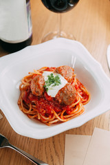 Pasta with cutlets and tomato sauce. Macaroni with meat and spices in the restaurant.