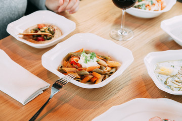 Pasta with cutlets and tomato sauce. Macaroni with meat and spices in the restaurant.