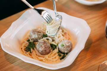 Pasta with cutlets and tomato sauce. Macaroni with meat and spices in the restaurant.