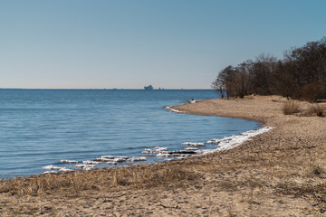 Remnants of ice and a view of the Gulf of Finland in early spring from the southern shore of Kronstadt.