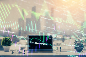 Fototapeta premium Stock market graph on background with desk and personal computer. Multi exposure. Concept of financial analysis.