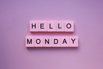 Hello monday words wooden cubes on a pink background © Kristina
