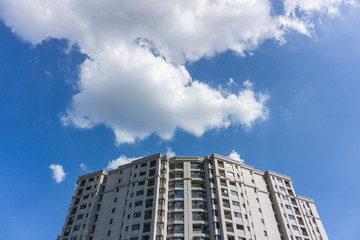 Fototapeta na wymiar Residential area under blue sky and white clouds